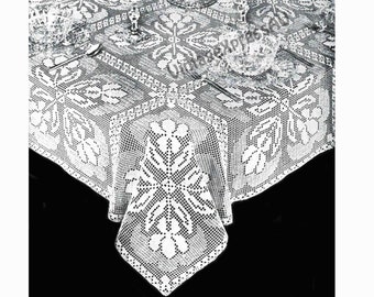 May include: A white crocheted tablecloth with a floral design. The tablecloth is laid out on a table with glasses and silverware.