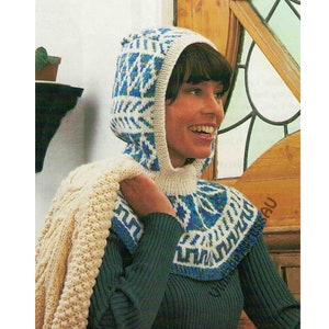 May include: A white knitted hooded cowl with a blue and green geometric pattern. The cowl is worn by a person with brown hair.