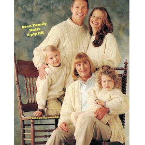 May include: A family of four wearing white Aran knit sweaters. The sweaters feature cable knit patterns. The family is posed in front of a textured background. The text "Aran Family Knits 8 ply DK" is visible in the top left corner of the image.