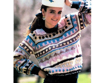 May include: A colorful knitted sweater with a geometric pattern and pom-poms. The sweater is worn by a person with a white hat and a blue ribbon in their hair.
