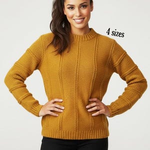 May include: A mustard yellow long-sleeve jumper featuring a ribbed knit texture with vertical panels, a crew neckline, and ribbed cuffs and hem. The text 4 sizes is printed in black near the upper right shoulder area of the garment.