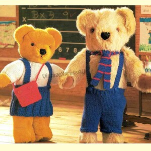 May include: Two knitted teddy bears wearing clothing. The bear on the left is wearing a white sweater, blue overalls, and a red bag. The bear on the right is wearing blue overalls, a red and blue striped scarf, and a white sweater.
