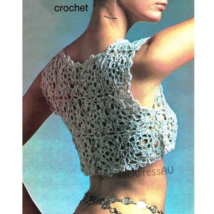 May include: A crochet top with a delicate openwork pattern. The top is sleeveless and has a scoop neckline. The crochet is a light blue color.