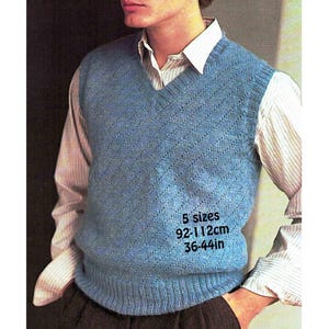 May include: A light blue knitted V-neck vest with a diagonal pattern. The vest is worn over a white and light brown striped shirt. Text on the vest indicates sizes from 36 to 44 inches (92-112cm).