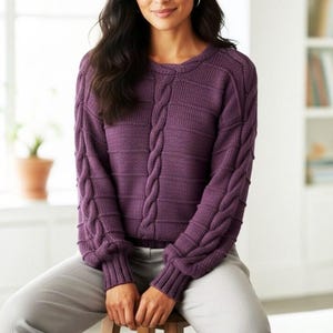 May include: A long-sleeved purple knit sweater featuring a prominent vertical cable knit pattern down the center and along the outer sleeves, complemented by horizontal ribbed textures across the chest and back, finished with ribbed cuffs.