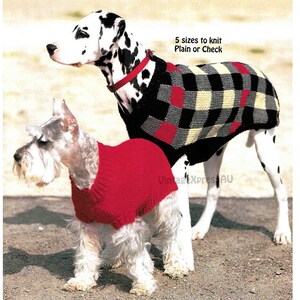 May include: Two dogs wearing knitted sweaters. A Dalmatian wearing a black, white and red plaid sweater and a small white dog wearing a red sweater. The text "5 sizes to knit Plain or Check" is visible in the image.
