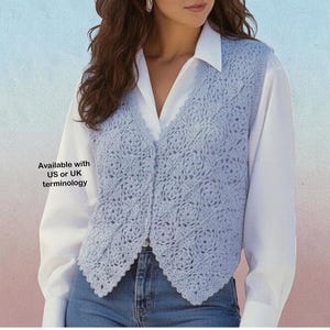 May include: A light blue crochet vest featuring a repeating square motif pattern with a V-neckline and a front button closure. The vest is worn over a white long-sleeve collared shirt and blue jeans. Text on the image reads: Available with US or UK terminology.