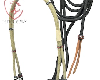 May include: A braided rope halter with a black and white braided rope noseband and a black rope lead rope. The halter is made of natural colored rope with red and black accents.