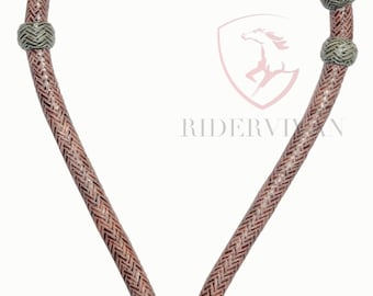 May include: A braided leather horse halter with a brown and green color scheme. The halter has a round, braided knot at the bottom and two smaller knots at the top.