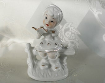 Porcelain figurine girl with book