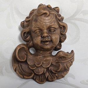 Putto angel head angel head breast feathers carved putto