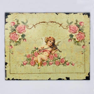 May include: A vintage-style illustration of a cherub playing a violin, surrounded by pink roses on a yellow background with a distressed, aged look.