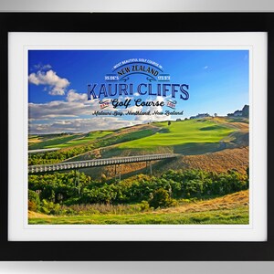 May include: A framed print of a golf course with a bridge over a stream. The print features the text "MOST BEAUTIFUL GOLF COURSE IN NEW ZEALAND", "KAURI CLIFFS", "Golf Course", "ESTD 2001", and "Malauri Bay, Northland, New Zealand".