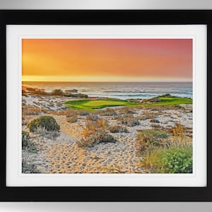 May include: A scenic photograph of a golf course with a green fairway and sand dunes. The ocean is in the background with a colorful sunset sky.