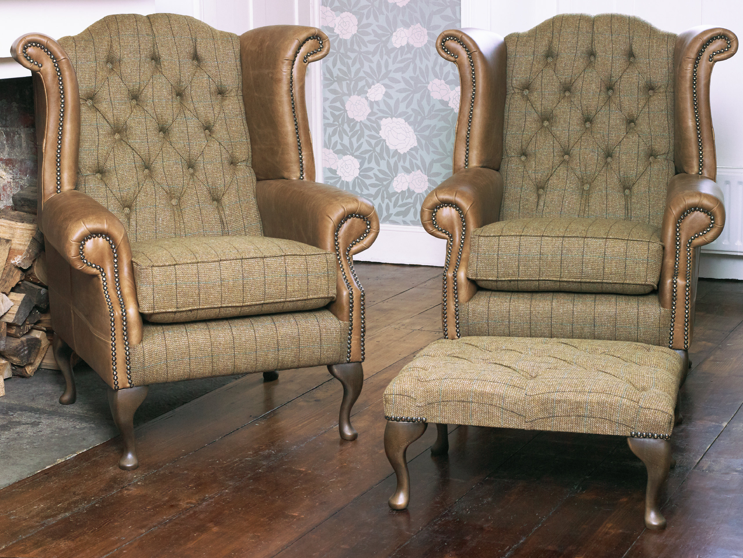 A Pair of Chesterfield Queen Anne Wing Back Chairs and Footstool