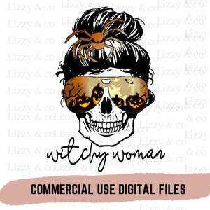 May include: A black and white skull with a witchy woman bun and spider on top. The skull is wearing sunglasses with a Halloween scene reflected in the lenses. The text "witchy woman" is below the skull.