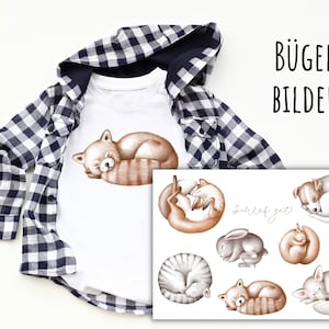 May include: Iron-on patches featuring various animals sleeping, including a red panda, fox, cat, rabbit, and dog. The patches are white with black outlines and the text "Schlaf gut" in black.