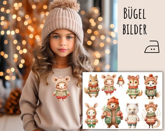May include: A young girl wearing a beige sweater and a matching knit hat with a pom-pom. The sweater features a cartoon mouse wearing a hat and sweater. The image also shows a sheet of iron-on animal designs, with the text "BÜGEL BILDER".