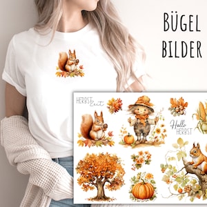 Può includere: T-shirt bianca con una piccola grafica di scoiattolo che tiene una noce e un foglio di trasferibili a tema autunnale. Il foglio include scoiattoli, zucche, uno spaventapasseri e il testo "Hallo Herbst".
