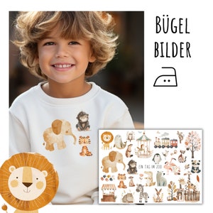 Op de afbeelding: Een set strijkbare patches met verschillende dieren, waaronder een leeuw, een olifant, een tijger, een aap en nog veel meer. De patches zijn ontworpen in een aquarelstijl met een lichtbruine en beige kleurenpalet. De tekst "Ein Tag im Zoo" is zichtbaar op de vel met patches.