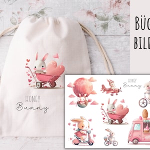 May include: A cream-coloured drawstring bag with a watercolour illustration of a white bunny in a pink wheelbarrow with a heart. The words "HONEY Bunny" are printed below. Additional bunny illustrations are shown on a separate sheet.