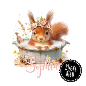 May include: A cute red squirrel wearing a flower crown is taking a bath in a blue and white tub. The tub is surrounded by green plants and the squirrel is smiling. The text "Sophia" is written below the tub in pink cursive. The text "BÜGEL BILD" is written in black on a black circle.