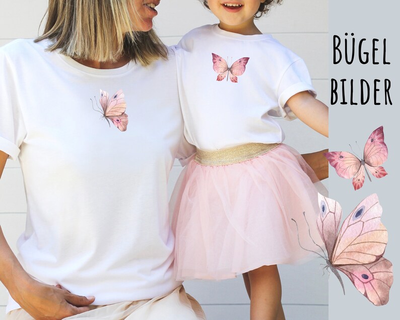 May include: Two white t-shirts with pink butterfly iron-on designs. The text "B&Uuml;GEL BILDER" is visible in the background.