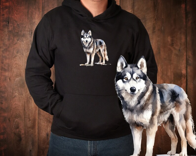 May include: A black hoodie with a watercolor illustration of a wolf on the front. The wolf is gray and white with a black nose and eyes. The hoodie has a drawstring hood and a kangaroo pocket.