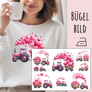 May include: Iron-on transfer design featuring a pink tractor pulling a wagon full of pink hearts. The tractor has a white smoke plume coming from the exhaust. There are multiple designs of the tractor and hearts in different sizes and arrangements.