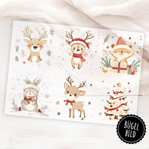Könnte beinhalten: Ein Bogen mit weihnachtlichen Bügelbildern mit Aquarellillustrationen von Rentieren, einem Hasen und einem Fuchs, die alle Winteraccessoires tragen. Ein Weihnachtsbaum ist ebenfalls abgebildet. Der Bogen hat einen weißen Hintergrund mit Schneeflocken.