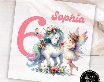 May include: A whimsical illustration featuring a white unicorn with a rainbow mane and floral accents, a fairy, and the name "Sophia" above a large pink number 6. A butterfly and flowers complete the design.