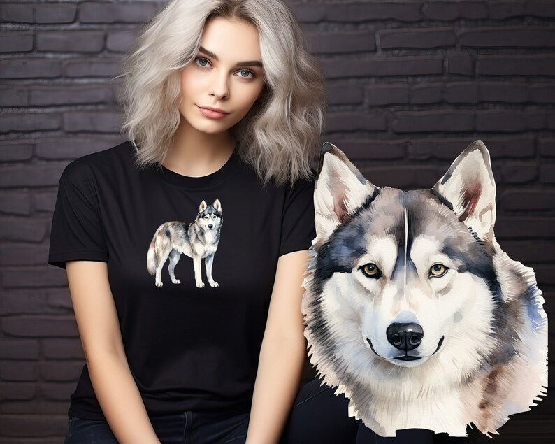 May include: A black t-shirt with a watercolor illustration of a grey and white husky dog. The dog is standing on all four legs and looking to the right. The woman wearing the shirt has blonde hair and is looking at the camera.
