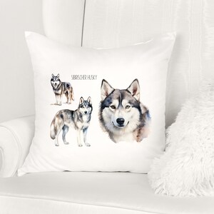 May include: White pillow with a watercolor illustration of three Siberian Huskies. The text "Siberian Husky" is printed on the pillow.
