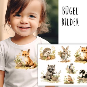 Könnte beinhalten: Ein weißes T-Shirt mit einer niedlichen Fuchs-Illustration. Der Fuchs sitzt auf einem Blätterbett und hält einen Korb. Das T-Shirt ist Teil eines Sets von Bügelbildern mit Waldtieren. Der Text "BÜGEL BILDER" ist im Bild sichtbar.