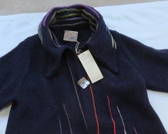 May include: A dark blue wool coat with a colorful striped collar and a tag that says "Handcrafted in Peru".