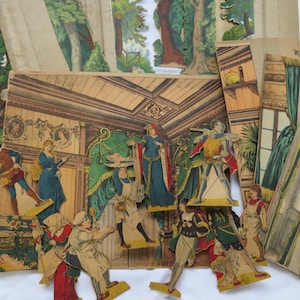 May include: A vintage paper doll set featuring a group of people in elaborate costumes. The dolls are cut out and ready to be played with. The set includes a variety of characters, including a queen, a knight, and a jester. The dolls are dressed in colorful clothing and have detailed features.