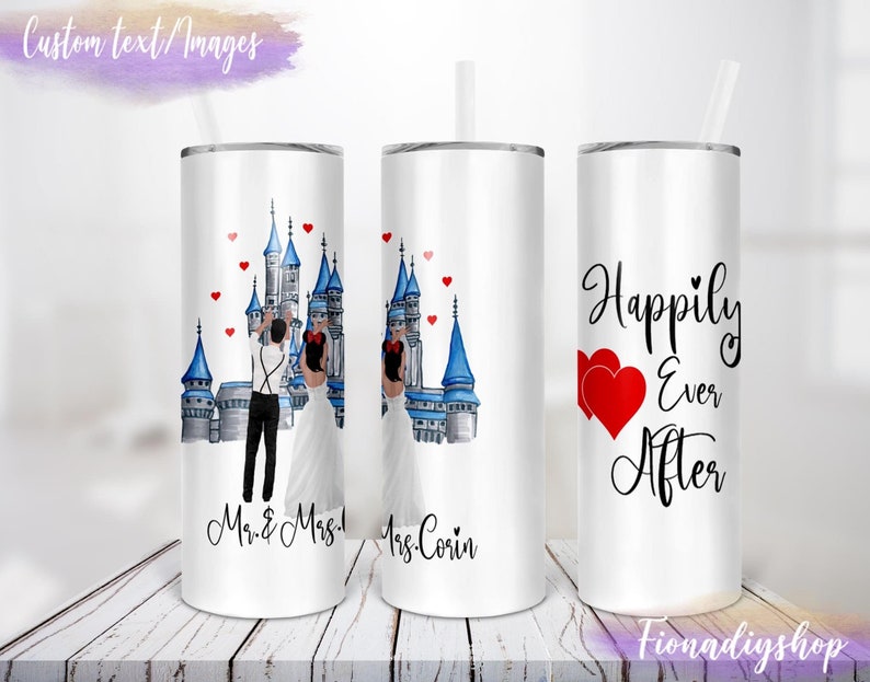 May include: Two stainless steel tumblers with a white background. One tumbler features a watercolor illustration of a couple in front of a blue castle with red hearts. The text "Mr. & Mrs." is below the image. The other tumbler features a watercolor illustration of a castle with red hearts and the text "Happily Ever After".