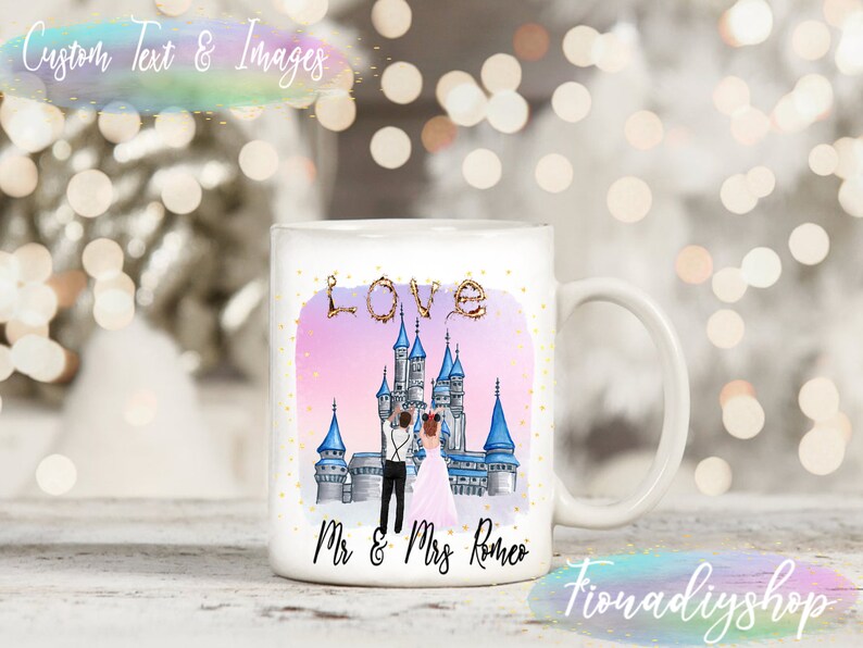 May include: White ceramic mug with a pink and purple ombre background featuring a cartoon illustration of a castle, a couple, and the words "LOVE" and "Mr. & Mrs. Romeo".