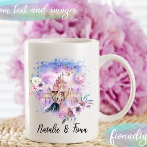 May include: White ceramic mug featuring a watercolor design with a castle, two figures, and floral accents. The mug has the text "Natalie & Fiona" and "Custom text and images". The mug is a standard size and has a curved handle.