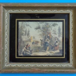 May include: A framed antique print depicting a rural scene with people gathering fruit from a tree. The print is in a gold-colored frame with a black mat.