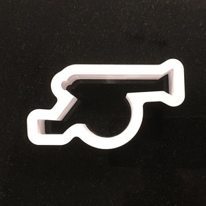 May include: White plastic cookie cutter shaped like a whistle.