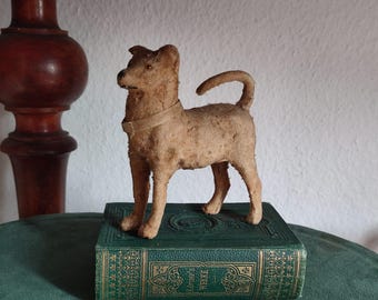 Old vintage dog, historical brocante toy, shabby antique patina, composition figure with felt fur, damaged, destroyed
