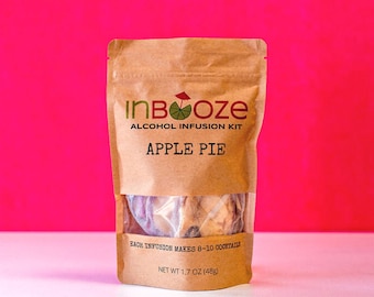 May include: A brown paper pouch with a clear window showing the contents. The pouch has the text "InBooze" and "ALCOHOL INFUSION KIT" in black text. The text "APPLE PIE" is in white text on a brown background. The pouch has the text "EACH INFUSION MAKES 8-10 COCKTAILS" and "NET WT 1.7 OZ (48g)" in black text.