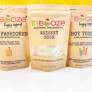 May include: Three kraft paper pouches for alcohol infusion kits. The pouches are labeled "Old Fashioned", "Whiskey Sour", and "Hot Toddy". Each pouch has the "InBooze" logo and text describing the cocktail. The "Old Fashioned" kit weighs 1.5 oz (43g).