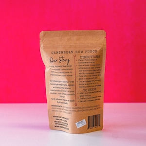 May include: A brown paper pouch with a label that reads "Caribbean Rum Punch" and includes instructions for infusing rum with dehydrated fruits, spices, and herbs. The label also includes a list of ingredients, such as dehydrated pineapple, oranges, cherries, limes, and bitter infused cane sugar cubes.