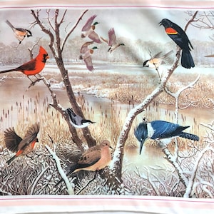May include: A fabric panel featuring a winter scene with various birds perched on snow-covered branches. A vibrant red cardinal, blue kingfisher, and other birds are depicted near a snowy river and reeds.