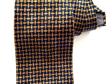 May include: A dark blue silk tie with a geometric pattern of gold diamonds.