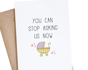 May include: A white card with the text "You can stop asking us now" in black. A cartoon baby carriage with purple, yellow, and green accents is below the text. Three pink stars are above the carriage.