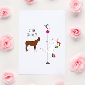 May include: A white card with a humorous illustration comparing a unicorn doing a pole dance to a horse. The text on the card reads "You" above the unicorn and "Other 60 yr olds" above the horse.