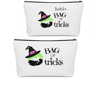 May include: White zippered pouch with a black and green witch's hat and lips with glitter. The text reads "Kelsi's Bag of tricks".